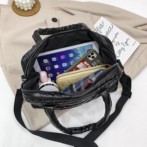 Quilted down tote bag showing large capacity for tablet, wallet and daily items