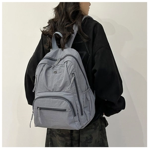 Detail view of multi-pocket nylon travel backpack with high-quality zipper and cord pullers