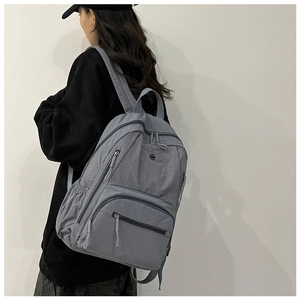 Side view of multi-pocket nylon backpack showing large capacity and padded shoulder straps