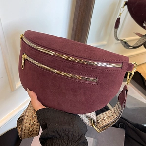 Burgundy suede chest bag with wide woven strap and gold zippers for trendy women
