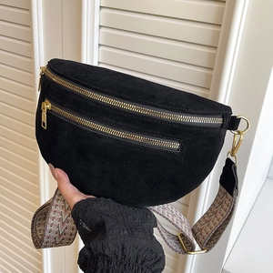 Black suede saddle fanny pack with wide woven shoulder strap and golden zippers