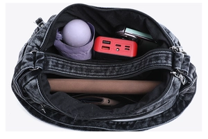 Top view of dark grey denim crossbody bag showing multi-compartment storage and capacity