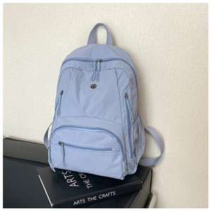 Detail view of large capacity lavender nylon backpack with multi-pocket and side pocket
