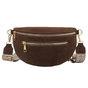 Deep brown suede moon bag with a colorful woven shoulder strap and golden zippers