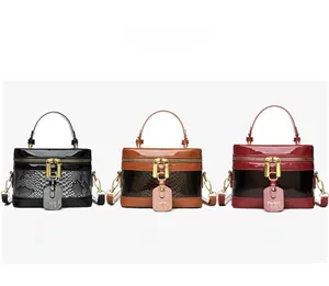 Detailed close-up of retro box handbags in gray, brown, and red with snakeskin texture