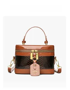 Detail of vintage box handbag with brown snakeskin pattern and gold zipper hardware
