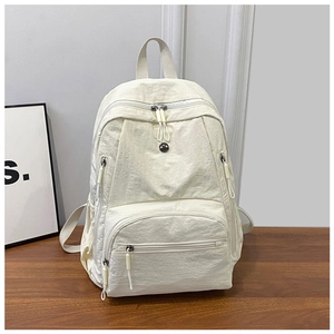 Detailed close-up of multi-pocket off-white nylon backpack with functional zip pockets