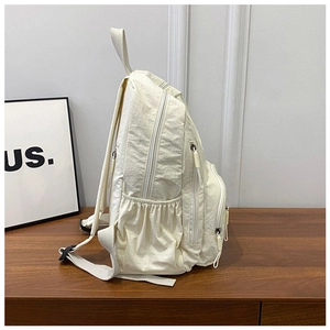 Side view of multi-pocket nylon backpack showing elastic side pockets and spacious layers