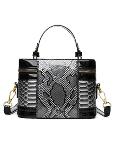 Detail of vintage box handbag featuring grey python skin texture and black faux leather