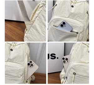 Detail view of multi-pocket nylon backpack showing storage capacity and reinforced straps