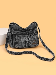 Black washed denim crossbody bag with multiple zippers and adjustable strap for women