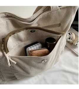 Detail of corduroy tote bag with magnetic snap pocket and spacious interior storage