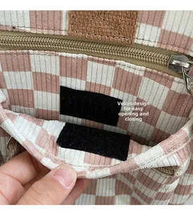 Macro detail of checkered tote bag interior with velcro and zipper closure design