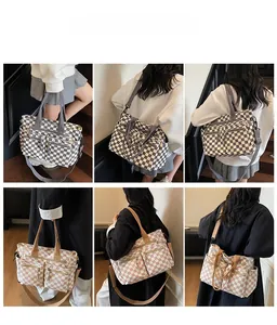 Detail view of checkerboard tote bag showing multiple pockets and adjustable shoulder strap