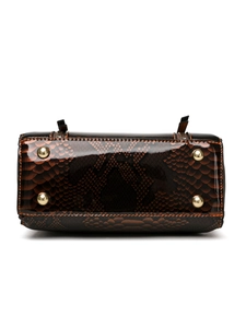 Detail of dark brown faux snakeskin handbag bottom with four protective gold metal feet