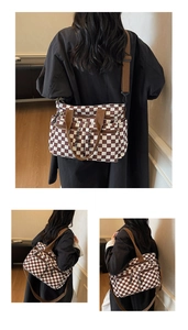 Detail view of large capacity checkerboard tote bag with dual front zipper pockets
