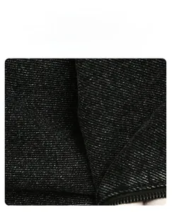 Gros plan sur la texture en denim noir doux et résistant avec tissage détaillé du sac