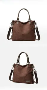 Detailed view of dark brown suede tote bag with leather handles and textile strap