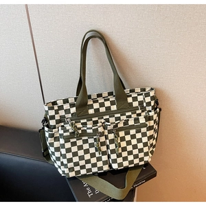 Detail of dark green checkerboard tote bag with multiple pockets and nylon shoulder strap