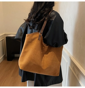 Brown suede tote bag side view showing large capacity and minimalist shoulder strap design