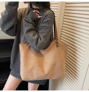Minimalist large khaki suede tote bag with dark brown shoulder straps on a model