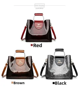 Three elegant crocodile pattern tote bags in red, brown, and black with metal logo detail