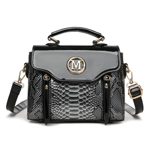 Black snake texture crossbody bag with gold M logo and glossy flap in a frontal view