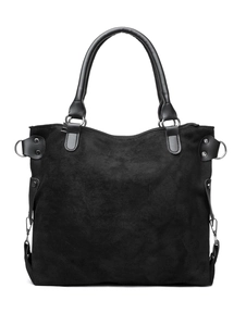 Detail view of large black suede tote bag with durable leather handles and metal D-ring