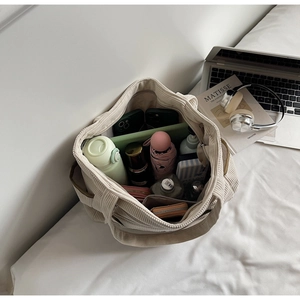 Detail of beige corduroy tote bag showing spacious interior with daily essentials