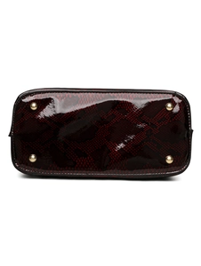 Detail of burgundy snakeskin embossed leather bag bottom with protective gold metal feet