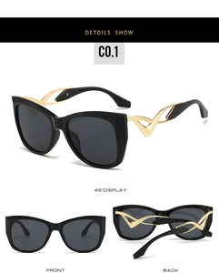 Cat eye sunglasses detail with wavy gold hollowed temples and black frame views