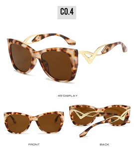 Detail view of retro cat-eye sunglasses with tortoiseshell frames and gold wavy temples