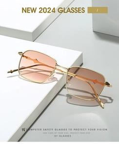 Detail of square gold metal sunglasses with brown gradient lenses and geometric temple design