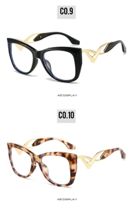 Detail view of cat eye sunglasses with gold V-pattern hollow temples in black and tortoiseshell