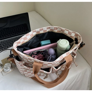 Top view of pink checkered tote bag showing interior space for water bottle and tablet