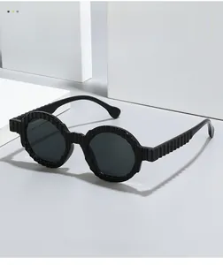 Detailed view of black round sunglasses featuring unique vertical textured frame and temples