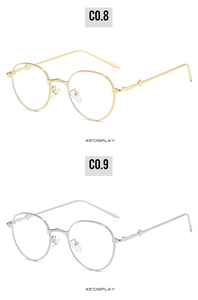 Detail view of retro oval metal glasses in gold and silver with minimalist frame design