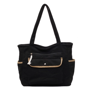 Front view of black corduroy tote bag with brown trim and multiple functional pockets