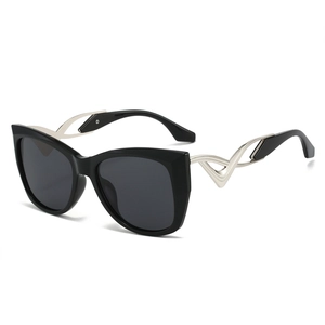 Fashionable oversized cat eye sunglasses with black frames and silver curved metal temples