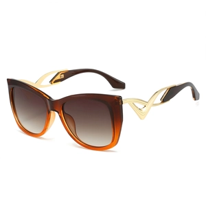Chic cat-eye sunglasses with amber gradient lenses and geometric golden metal temples