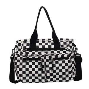 Black and white checkerboard corduroy tote bag with dual front pockets and adjustable strap
