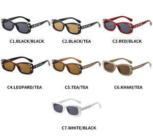 Multiple stylish narrow rectangular sunglasses with rhinestone accents in seven color options