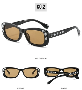Detail view of oval rhinestone sunglasses with black frame and brown lenses