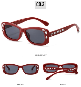 Detail view of red oval sunglasses with rhinestone accents from multiple angles