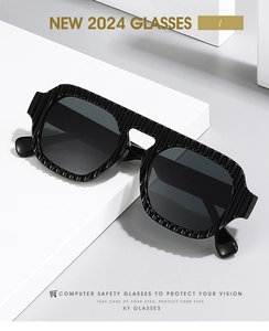 Close-up of black pilot sunglasses with modern ribbed texture frame on a geometric stand