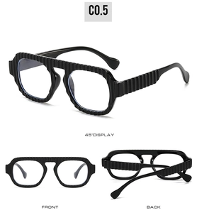 Detail view of black aviator sunglasses with unique vertical striped textured frames