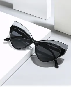 Detail of cat-eye sunglasses featuring contrast color stitching and grey lenses