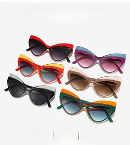 Flat lay of retro cat-eye sunglasses in various bold color combinations and color-blocking