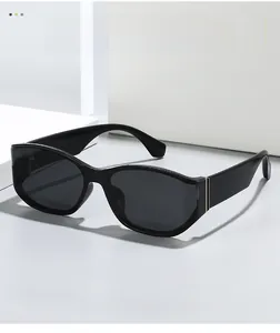 Detail of square oversized sunglasses showing gold metal hinges and black frame texture