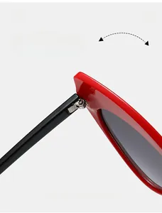 Detailed macro view of durable metal spring hinges on red cat-eye sunglasses frames